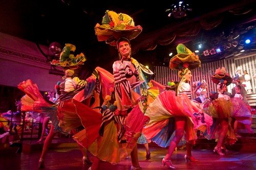 A team of graceful dancers dancing with joy in one of the performance in Parisien Cabaret, Havana, Cuba.