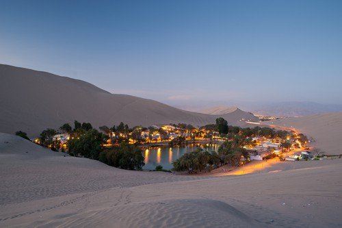 THis image shows the oasis town of Huacachina, Peru - ultimate peru travel guide