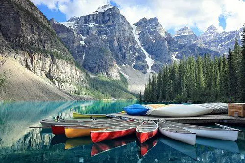 Canoes on a jetty at Moraine lake, Banff national park in the Rocky Mountains, Alberta, Canada