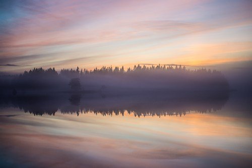 Sunrise mists over an inland sweedish lake - ultimate sweden travel guide