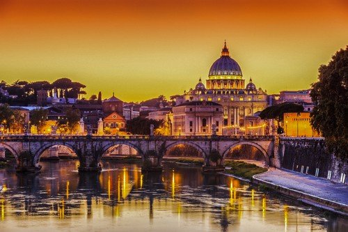 San Pietro Basilica and Ponte St Angelo at sunset. Rome, Italy