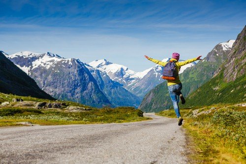 Young hipster female traveler enjoy the travel. Adventure is coming. - Norway travel guide