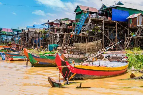 Boats and stilt houses in Kampong Phluk floating village, Tonle Sap lake, Siem Reap Province, Cambodia - Budget Cambodia Travel Guide