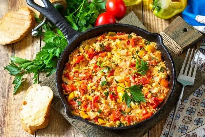 Traditional Turkish dish of Mememen (fried vegetables with scrambled egg) in a cast iron frying pan.