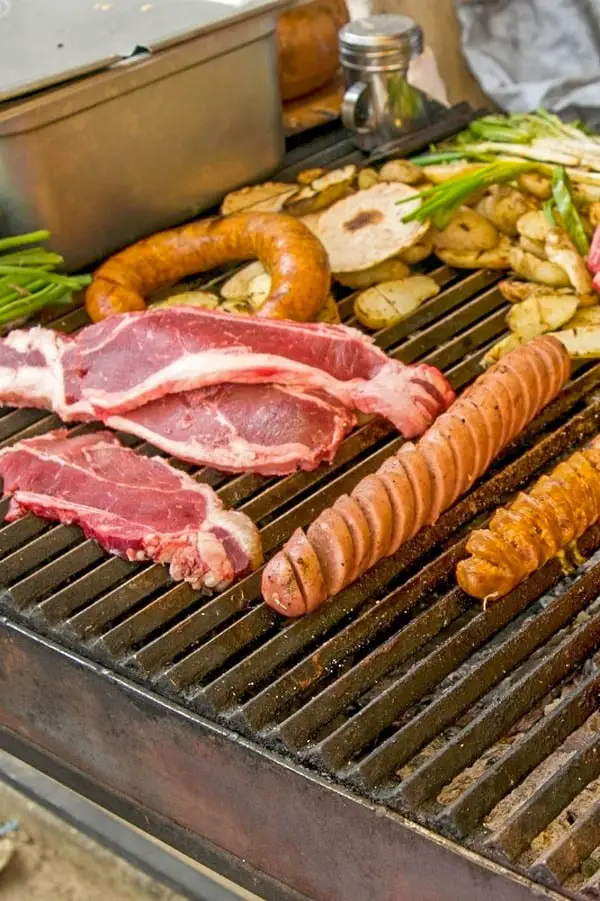 A grill full of Guatemalan chorizos, sausage, steak and other my