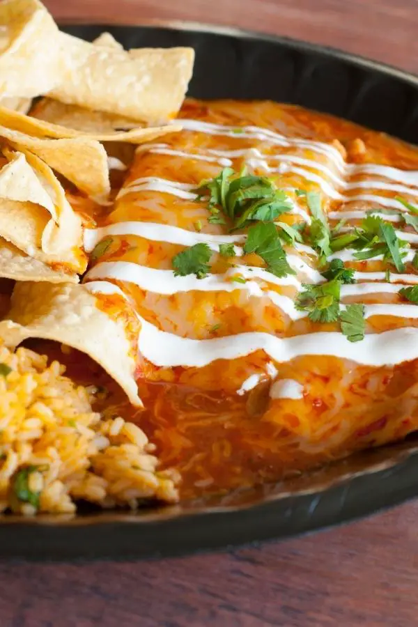 Mexican Recipes - Enchilada platter with loads of beans and sauce.