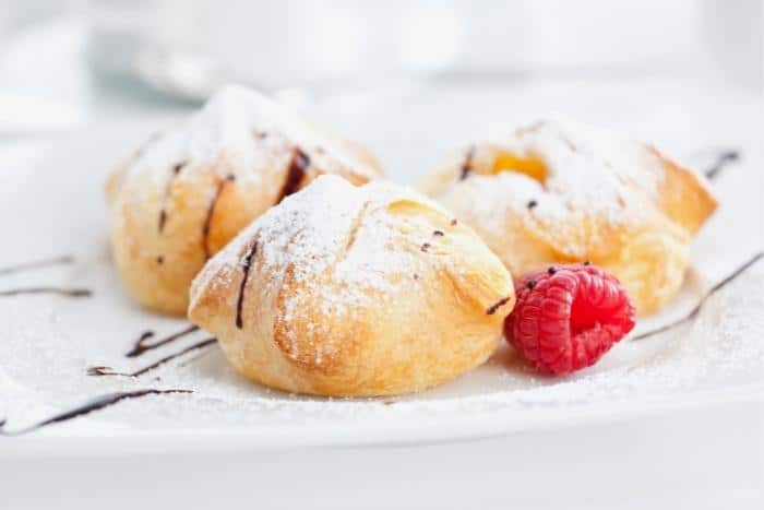 Austrian Pastry filled with sweet curd cheese and decorated with sugar, chocolate and raspberry. - Austrian Recipes