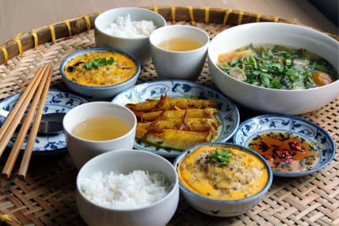 Traditional Foods of Vietnam: Sand goby fish cooked with sauce, rice, steamed pork with egg, pickled mustard cabbage, soup, etc