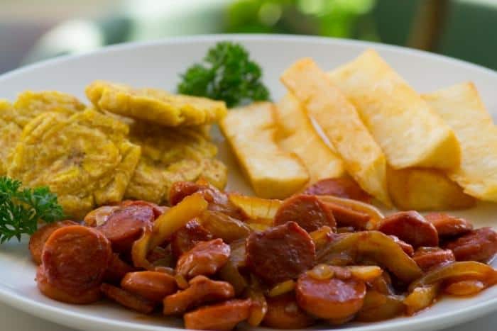 Typical Panamanian Breakfast -- Fried Cassava, Fried Smashed Green Plantain and Frankfurters.