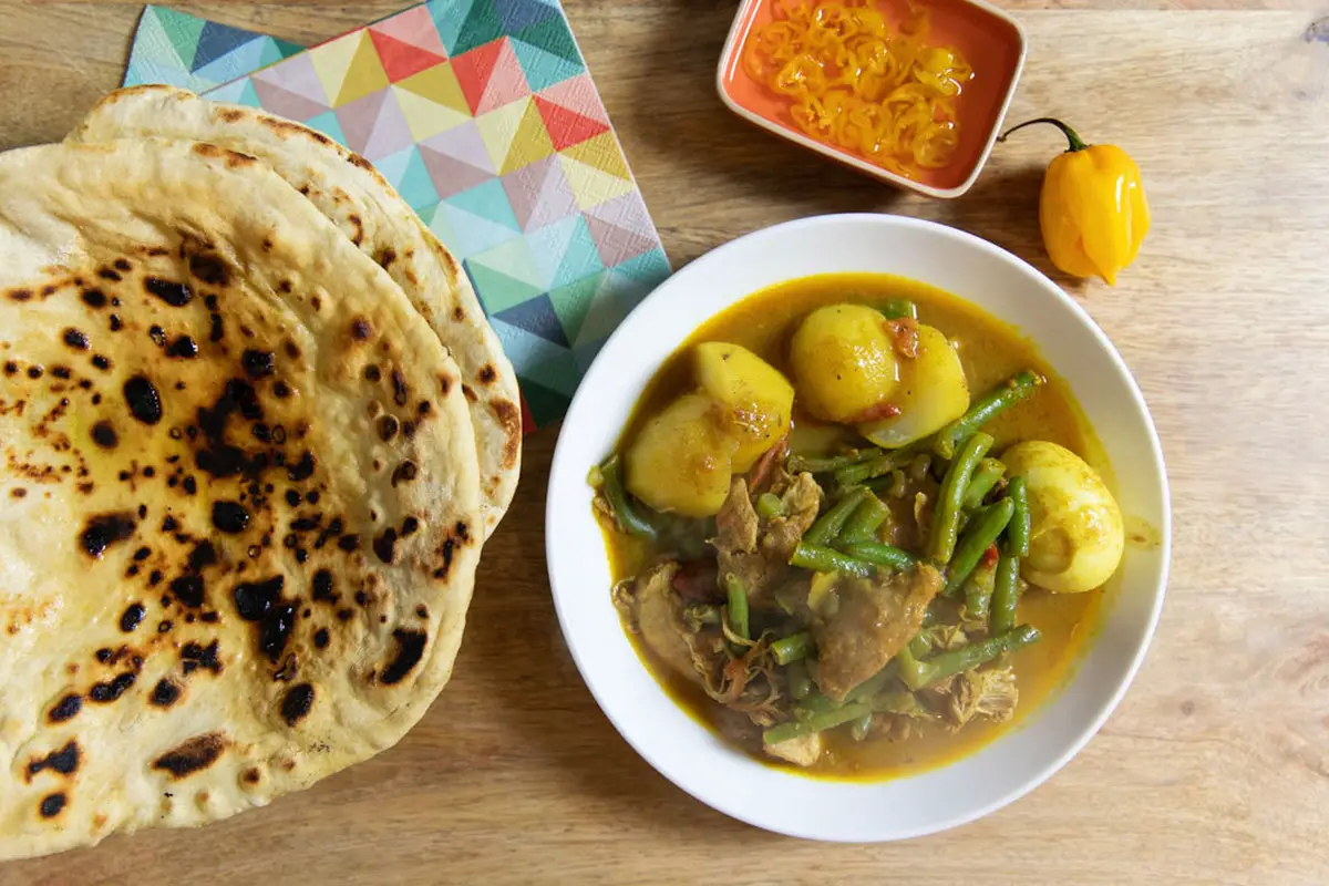 11. Surinamese Chicken Curry with Potato Filled Roti